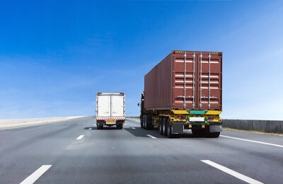 Truck on highway road with container, transportation concept.,import,export logistic industrial Transporting Land transport on asphalt expressway with blue sky